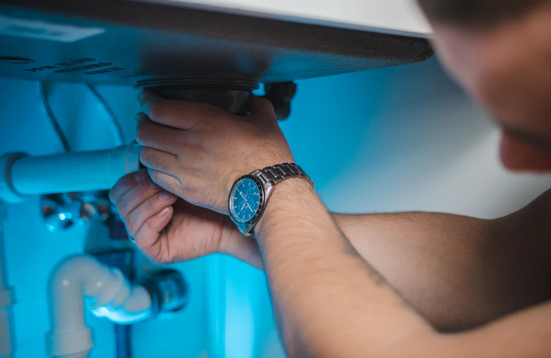 Technician installing a wall-mounted RO water purifier