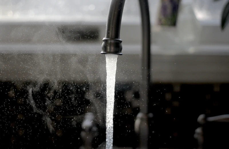 Clear filtered water running from a kitchen tap after an RO service